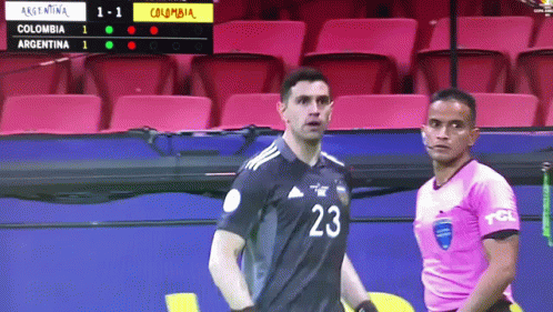 A Soccer Player With The Number 23 On His Jersey Stands Next To A Referee GIF