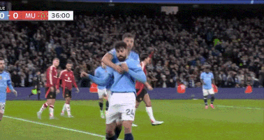 a soccer player with the number 24 on his shorts is hugging another player on the field
