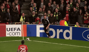 a soccer player with the number 25 on his jersey is kicking a ball