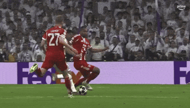 a soccer player with the number 27 on his jersey kicking the ball