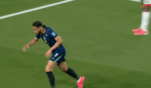 a soccer player with the number 29 on his jersey is jumping in the air
