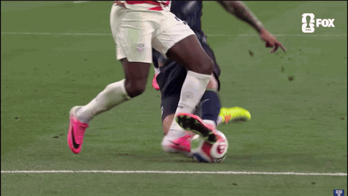 a soccer player with the number 3 on his shirt is being tackled by another player
