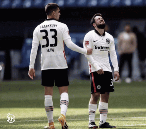 A Soccer Player With The Number 33 On His Back Talks To Another Player GIF