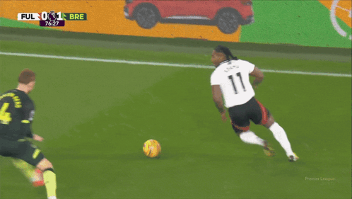 A Soccer Player With The Number 4 On His Back Kicks The Ball GIF