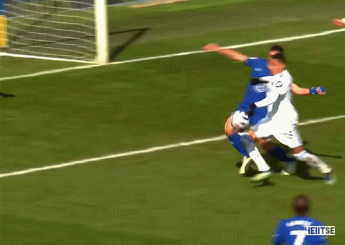 A Soccer Player With The Number 4 On His Jersey Is Surrounded By Other Players GIF