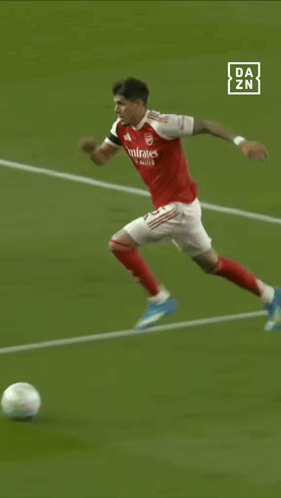 a soccer player with the number 5 on his back is kicking the ball