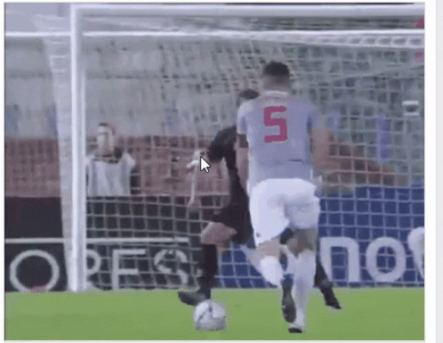 a soccer player with the number 5 on his jersey is kicking a ball