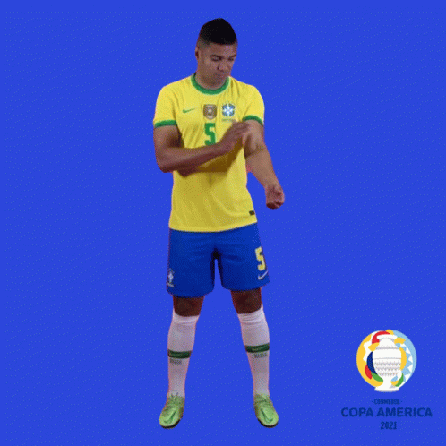a soccer player with the number 5 on his jersey stands in front of a blue background