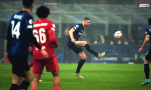a soccer player with the number 66 on his back is kicking the ball
