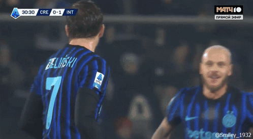 a soccer player with the number 7 on his back is hugging his teammates