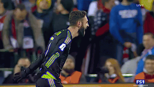 a soccer player with the number 7 on his jersey is celebrating