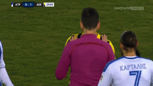 A Soccer Player With The Number 8 On His Jersey Talks To A Referee GIF
