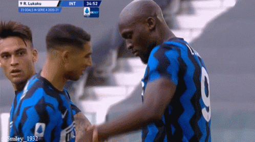 a soccer player with the number 9 on his back shakes hands with another player
