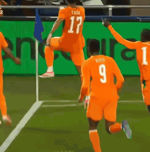 a soccer player with the number 9 on his jersey is jumping in the air