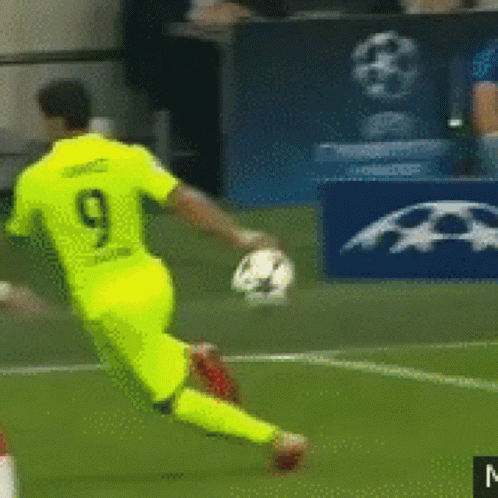 A Soccer Player With The Number 9 On His Jersey Is Kicking A Ball GIF