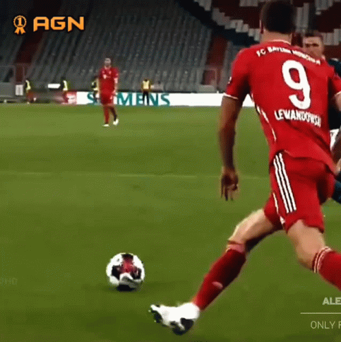 A Soccer Player With The Number 9 On His Jersey Is Kicking The Ball GIF