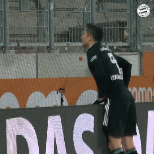 A Soccer Player With The Number 9 On His Jersey Leans Over A Wall GIF