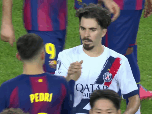 A Soccer Player With The Number 9 On His Jersey Shakes Hands With Another Player GIF