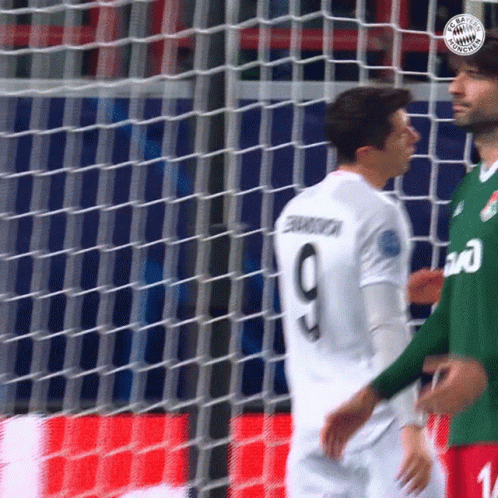 A Soccer Player With The Number 9 On His Jersey Stands Next To Another Player GIF