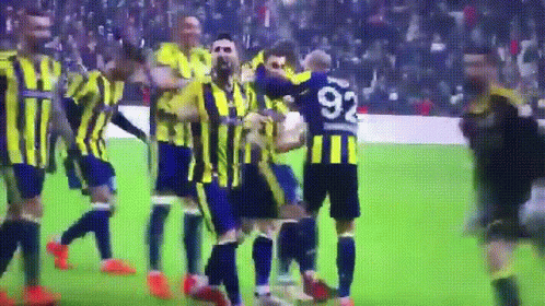 A Soccer Player With The Number 92 On His Jersey Is Surrounded By His Teammates GIF
