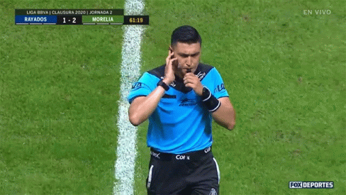 A Soccer Referee Is Pointing At A Scoreboard That Says Rayados 1-2 Morelia GIF