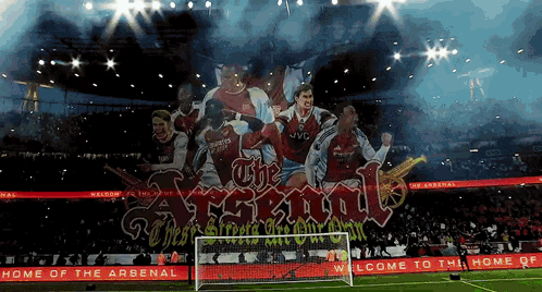 A Soccer Stadium With A Banner That Says The Arsenal GIF