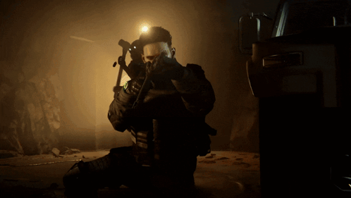 A Soldier Is Kneeling Down And Holding A Gun With The Number 11 On His Chest GIF