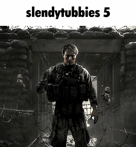 A Soldier Is Standing In Front Of A Barbed Wire Fence Holding A Gun . GIF