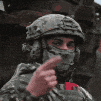 Soldier Wearing Helmet And Mask Giving Middle Finger GIF