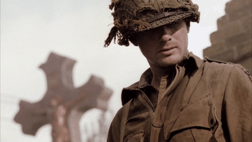 A Soldier Wearing A Helmet And A Shirt That Says ' U.s. Army ' On The Sleeve GIF