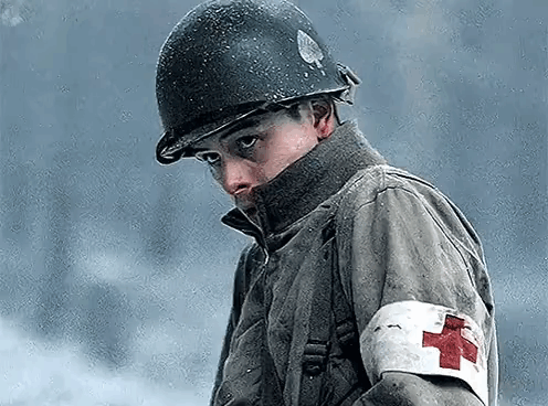 A Soldier With A Red Cross On His Arm Is Wearing A Helmet . GIF