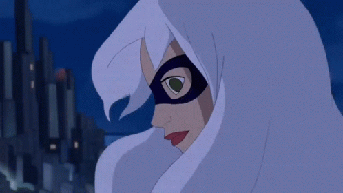 A Spider Man Hanging Upside Down In Front Of A City At Night GIF