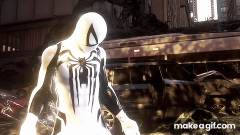 A Spider Man In A White Suit Is Standing In Front Of A Building GIF