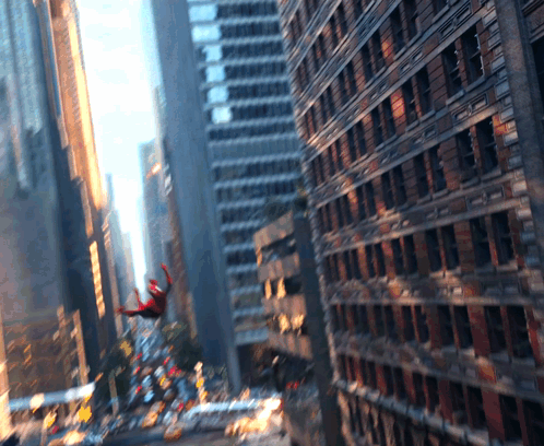 A Spider-Man Is Flying Through The Air In A City GIF