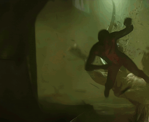 A Spider-Man Is Flying Through The Air In A Dark Room GIF