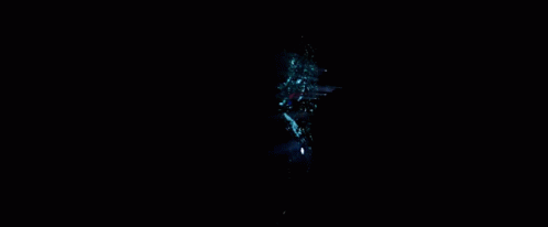 A Spider Man Is Standing In Front Of A Green Light GIF