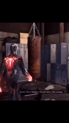A Spider-Man Talking To Another Spider-Man In Front Of A Punching Bag That Says Naga On It GIF