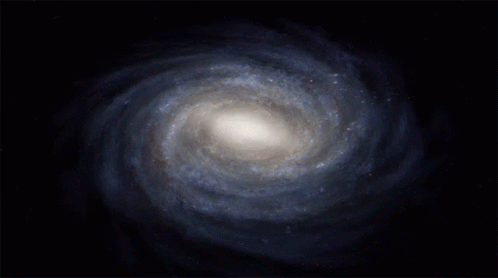 A Spiral Galaxy In A Dark Blue Sky GIF