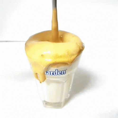 A Spoon Is Being Poured Into A Glass That Says Arden GIF