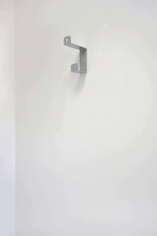 A Stack Of Black Pans Hanging On A Wall GIF
