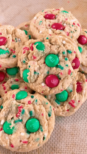 A Stack Of Cookies With M & M 'S And Sprinkles On Them GIF