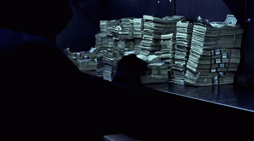 A Stack Of Money On A Table With A Blue Ribbon That Says ' United States Of America ' On It GIF