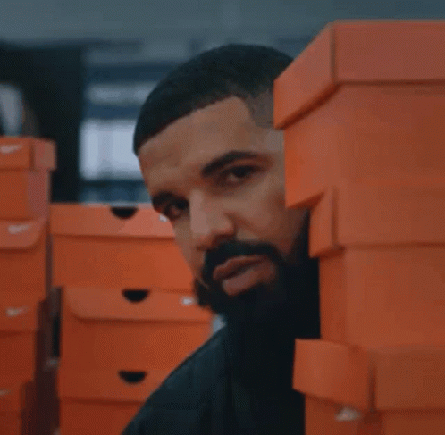 A Stack Of Orange Nike Boxes In A Store GIF