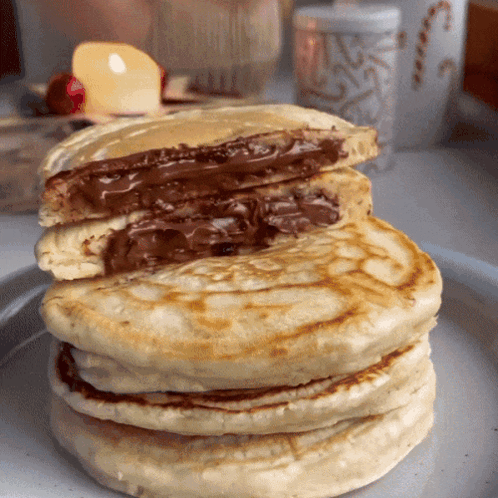 A Stack Of Pancakes With A Chocolate Filling GIF
