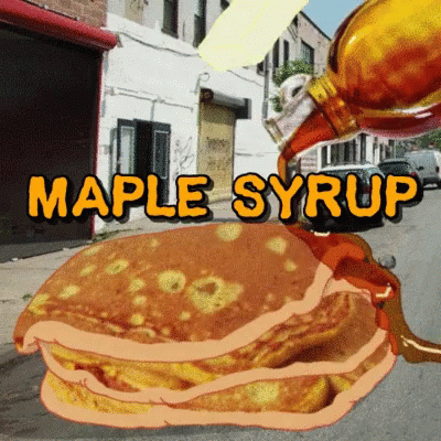 a stack of pancakes with maple syrup being poured over them