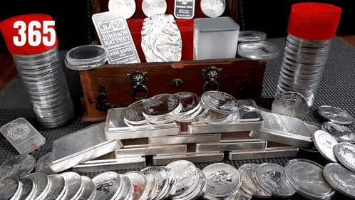 A Stack Of Silver Coins With A Jm Johnson Matthew Coin In The Background GIF