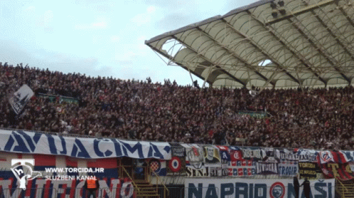 a stadium full of people with a banner that says avjacma