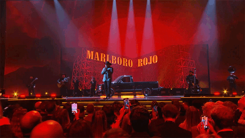 A Stage With A Truck In Front Of A Marlboro Rojo Sign GIF