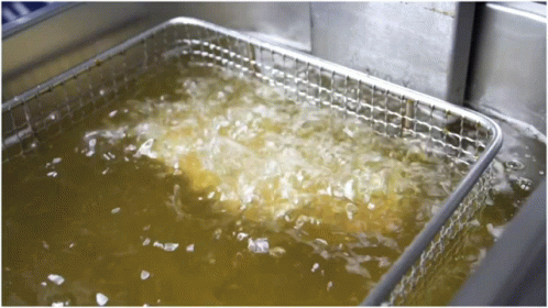A Stainless Steel Fryer Is Filled With A Yellow Liquid GIF