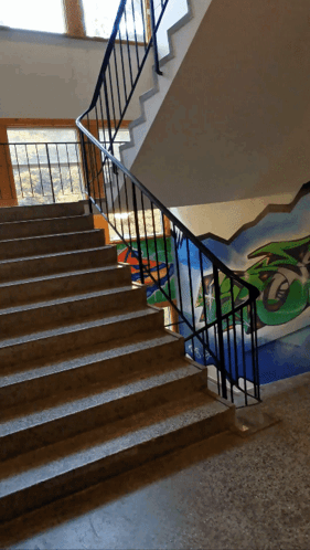 A Staircase With Graffiti On The Wall And The Letter T GIF